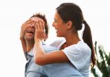 Woman covering man's eyes