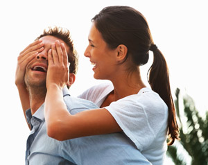 Woman covering man's eyes
